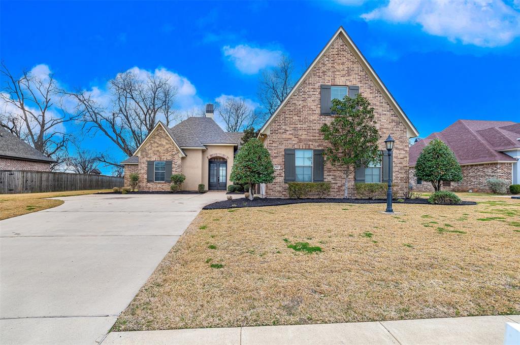 106 Pear Tree Lane Benton, LA 71006 - Photo 2 of 26 a view of the house with palm trees