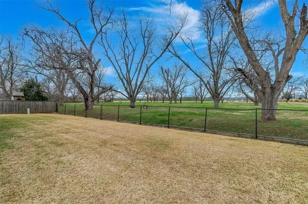 a view of dirt field with trees
