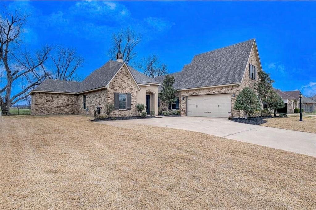 106 Pear Tree Lane Benton, LA 71006 - Photo 3 of 26 a front view of a house with a yard