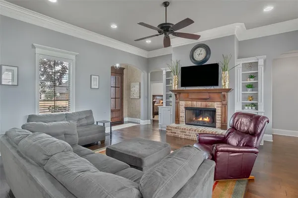 a living room with furniture a fireplace and a flat screen tv