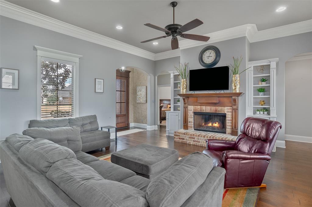 106 Pear Tree Lane Benton, LA 71006 - Photo 7 of 26 a living room with furniture a fireplace and a flat screen tv