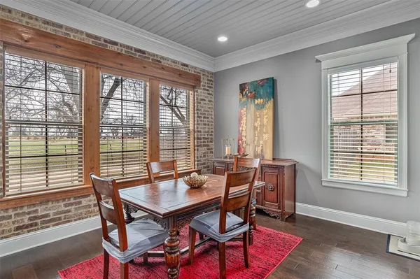 a view of a dining room with furniture and windows