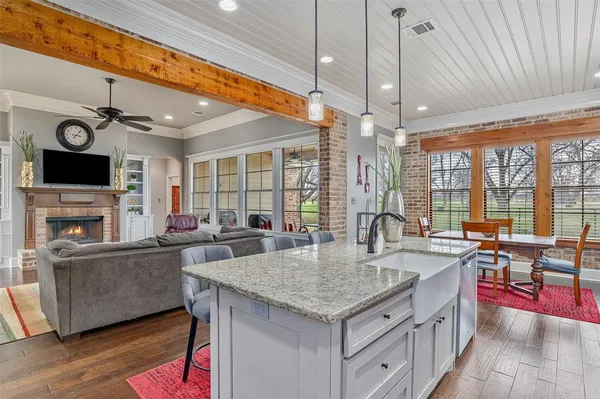 a kitchen with sink cabinets and wooden floor
