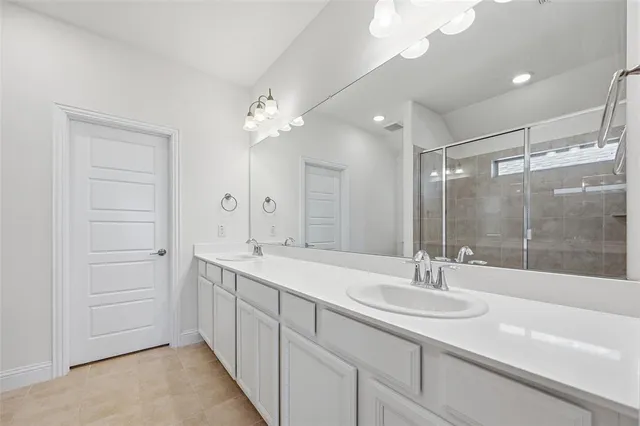 a bathroom with a sink double vanity and a mirror