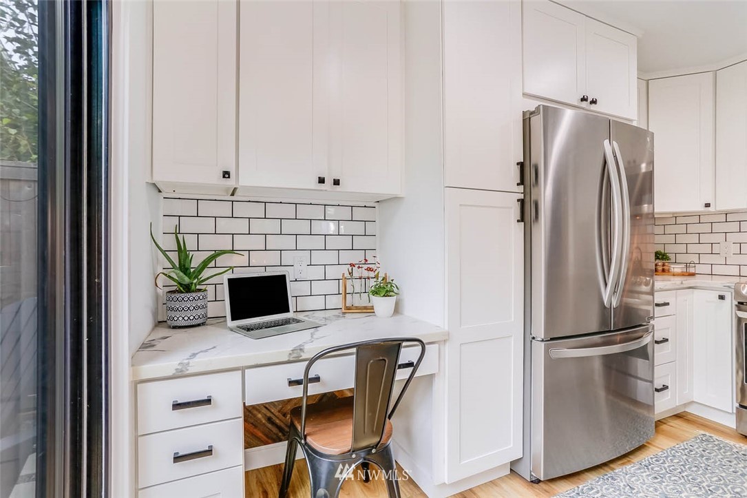 1108 North 41st Street Seattle, WA 98103 - Photo 11 of 32 a kitchen with stainless steel appliances a refrigerator sink and microwave