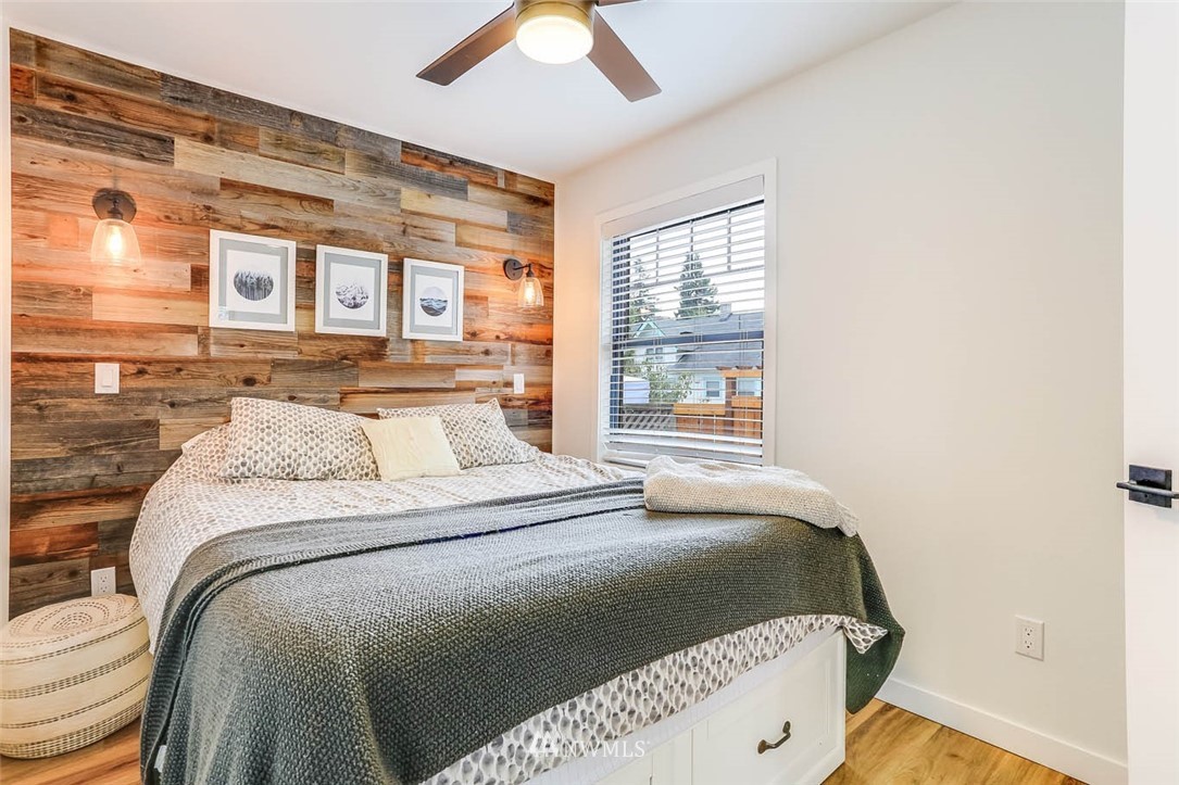 1108 North 41st Street Seattle, WA 98103 - Photo 17 of 32 a bedroom with a bed and a window