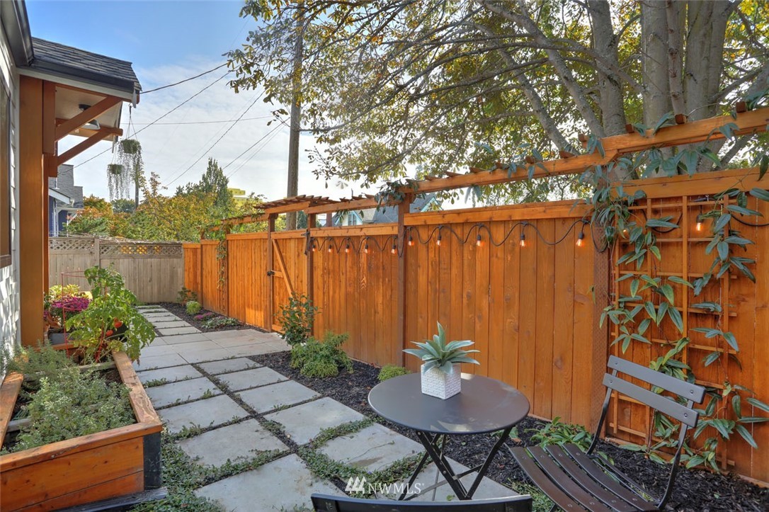 1108 North 41st Street Seattle, WA 98103 - Photo 28 of 32 a backyard of a house with lake view and outdoor seating