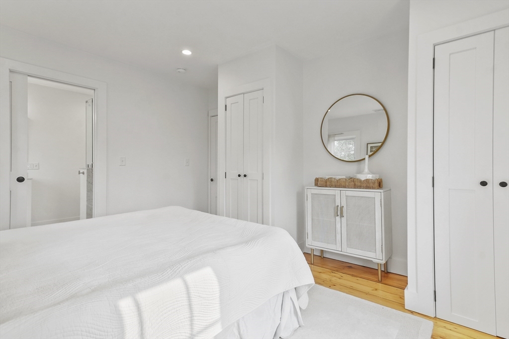 224 Elm Street Amesbury, MA 01913 - Photo 14 of 29 a bedroom with a bed and a mirror
