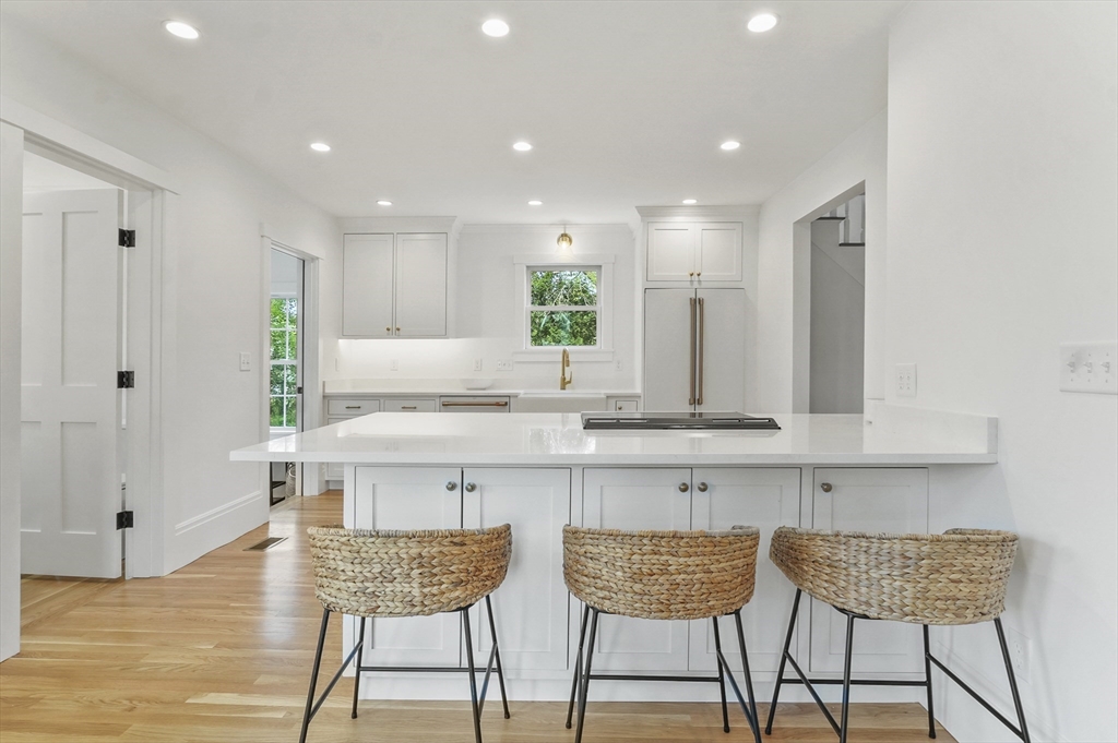 224 Elm Street Amesbury, MA 01913 - Photo 2 of 29 a kitchen with granite countertop white cabinets and chairs