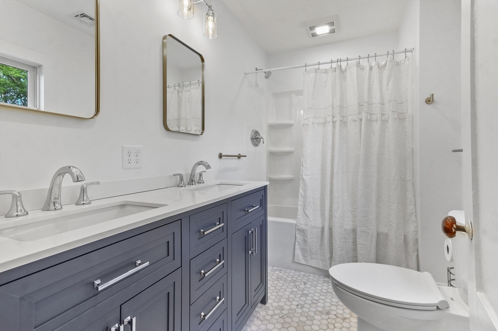224 Elm Street Amesbury, MA 01913 - Photo 21 of 29 a bathroom with a double vanity sink mirror and toilet
