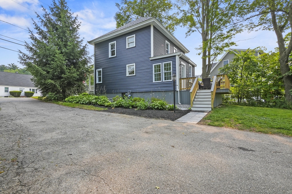 224 Elm Street Amesbury, MA 01913 - Photo 25 of 29 a front view of a house with a yard and garage