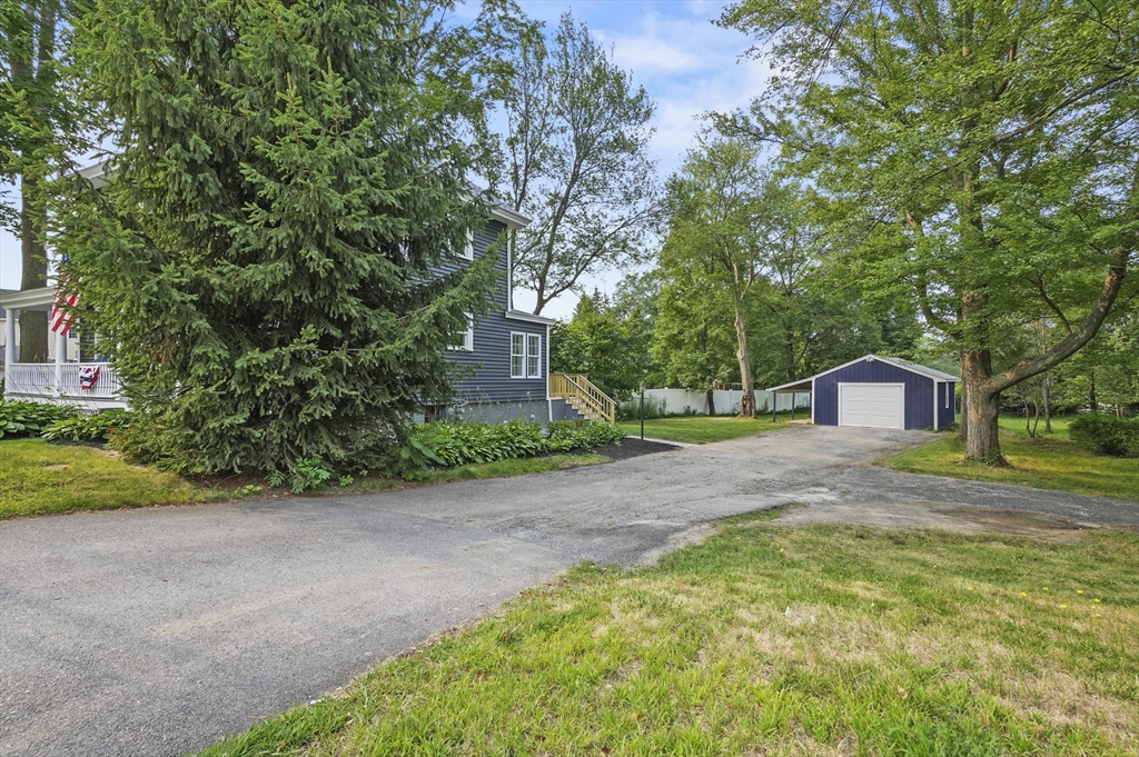 224 Elm Street Amesbury, MA 01913 - Photo 26 of 29 a view of a house with a yard and large trees