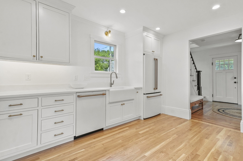 224 Elm Street Amesbury, MA 01913 - Photo 3 of 29 a kitchen with white cabinets and sink