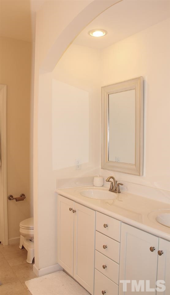 1300 Rodessa Run Raleigh, NC 27607 - Photo 11 of 16 a bathroom with a sink a toilet and a mirror