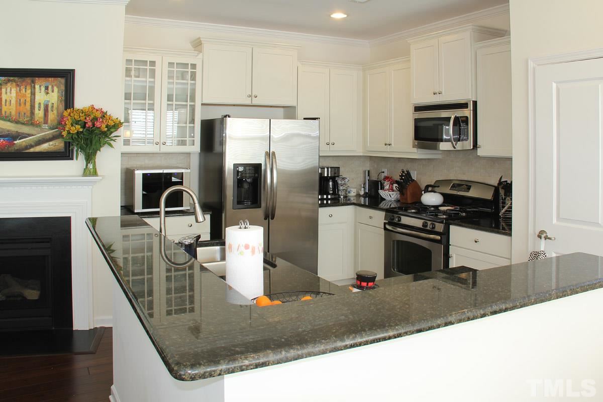 1300 Rodessa Run Raleigh, NC 27607 - Photo 4 of 16 a kitchen with stainless steel appliances granite countertop a refrigerator a stove top oven a sink and dishwasher
