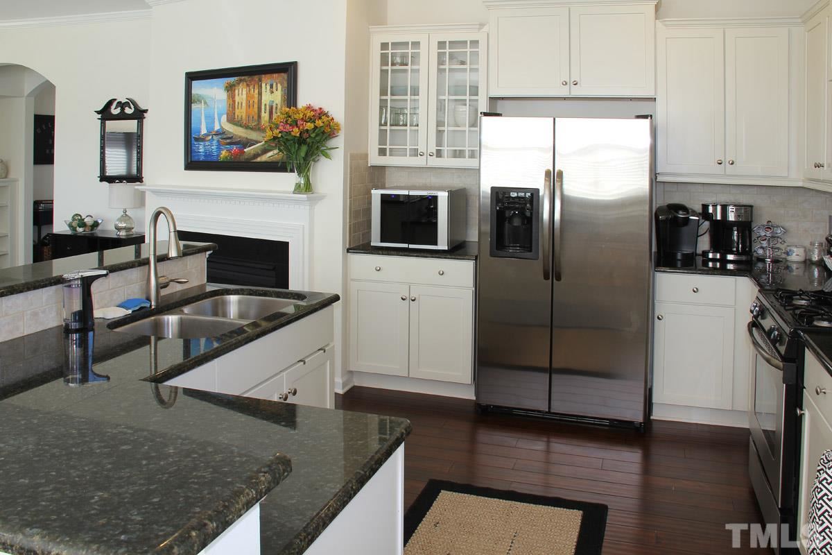 1300 Rodessa Run Raleigh, NC 27607 - Photo 5 of 16 a kitchen with granite countertop a refrigerator stove and sink