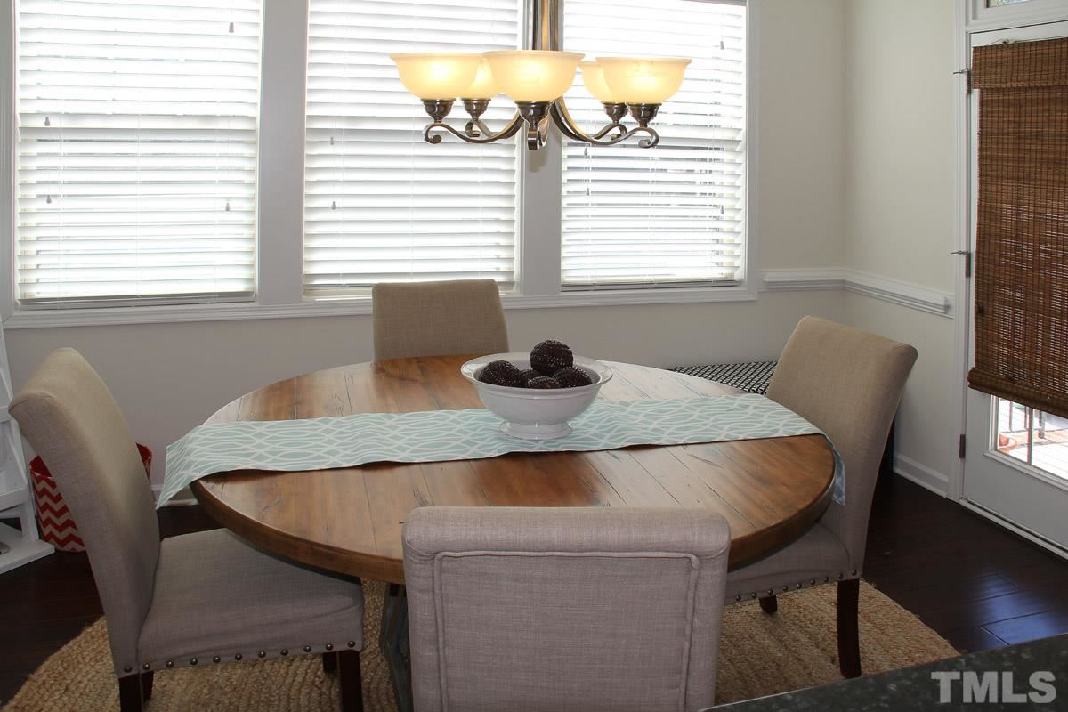 1300 Rodessa Run Raleigh, NC 27607 - Photo 7 of 16 a view of a dining room with a table and chairs