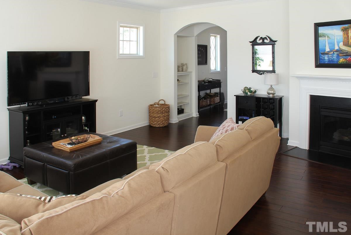 1300 Rodessa Run Raleigh, NC 27607 - Photo 8 of 16 a living room with furniture a flat screen tv and a fireplace