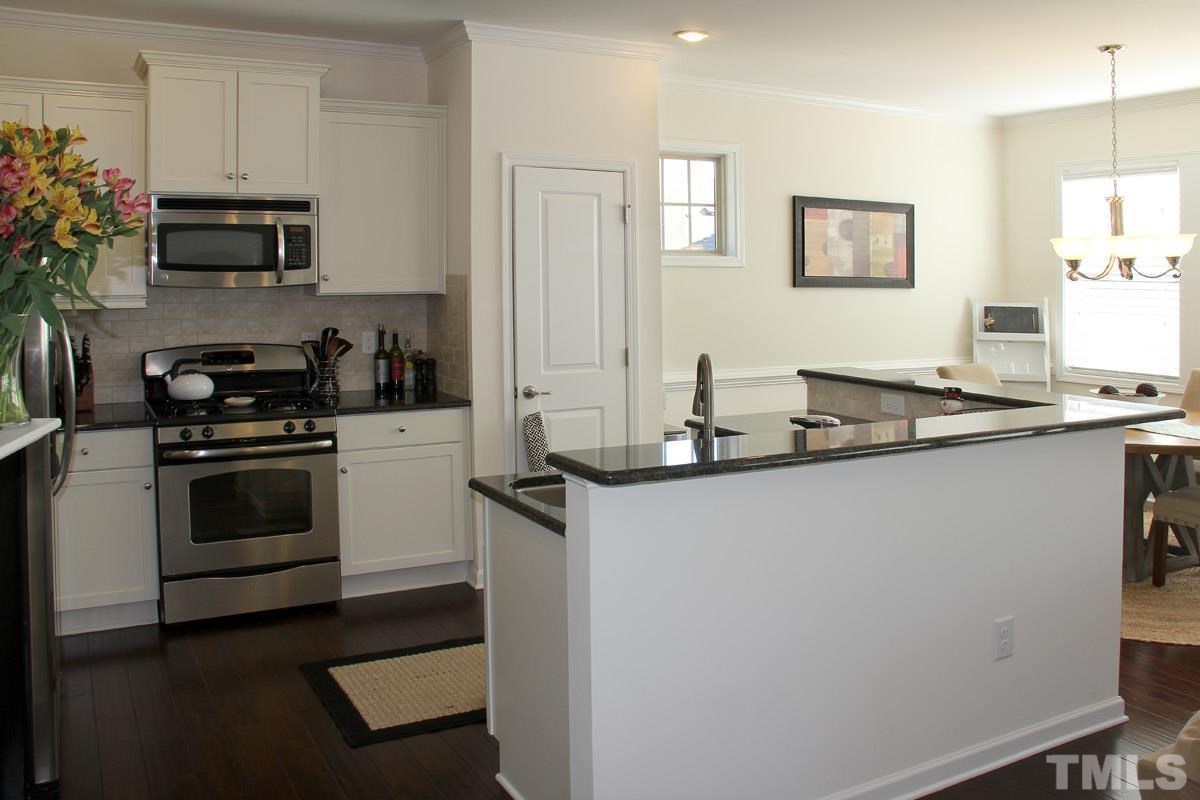 1300 Rodessa Run Raleigh, NC 27607 - Photo 9 of 16 a kitchen with granite countertop a sink cabinets and stainless steel appliances