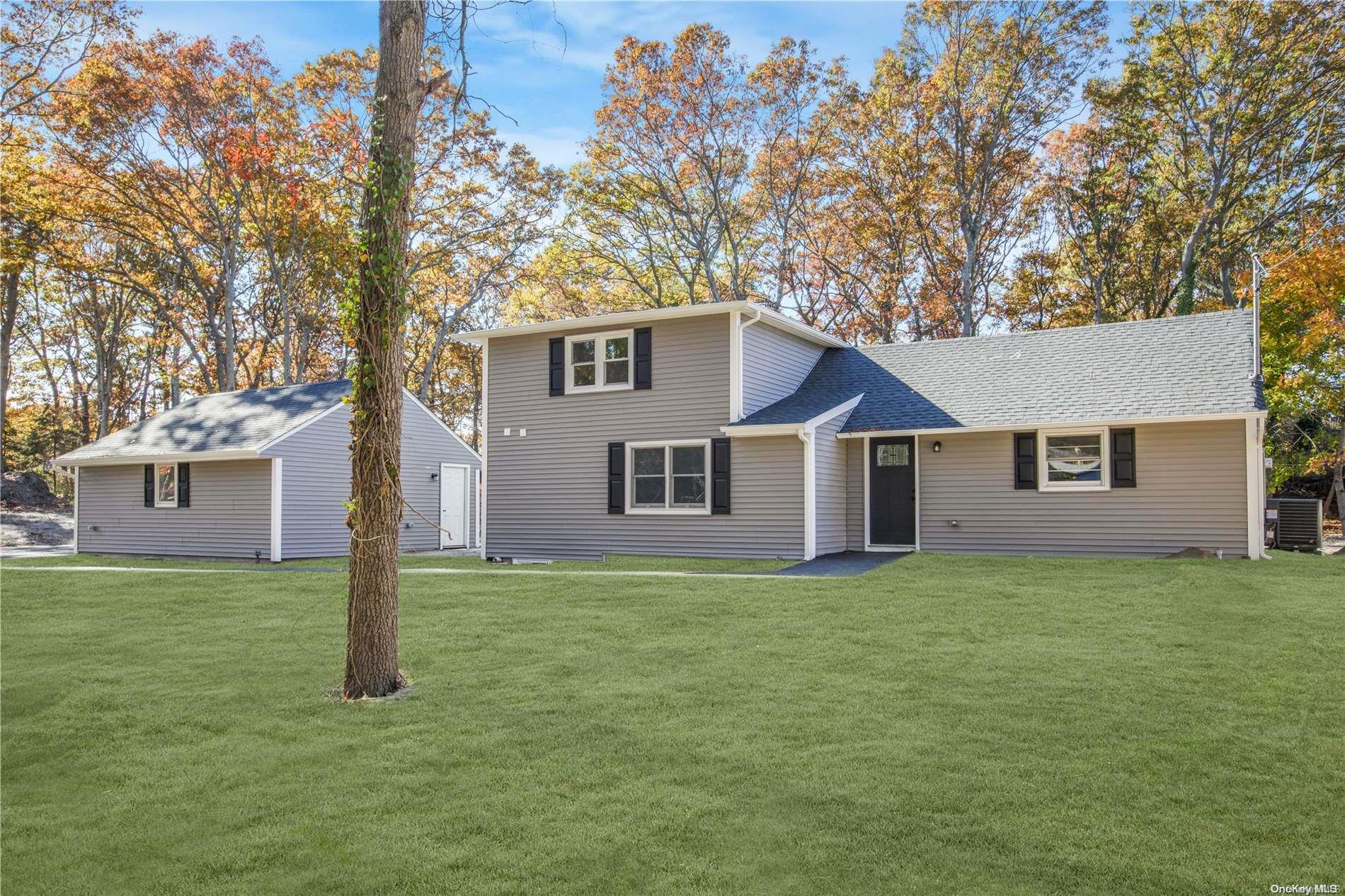 a house that has a tree in front of it