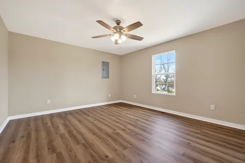 wooden floor in an empty room with a window