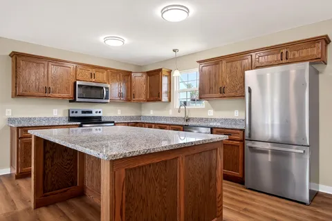 a kitchen with a refrigerator sink and microwave