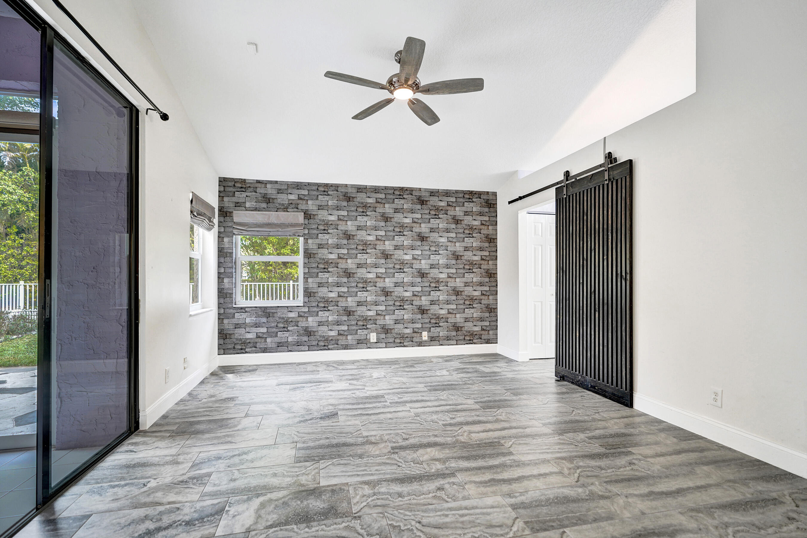 8062 Cassia Drive Boynton Beach, FL 33472 - Photo 17 of 70 a view of an empty room with a ceiling fan and window