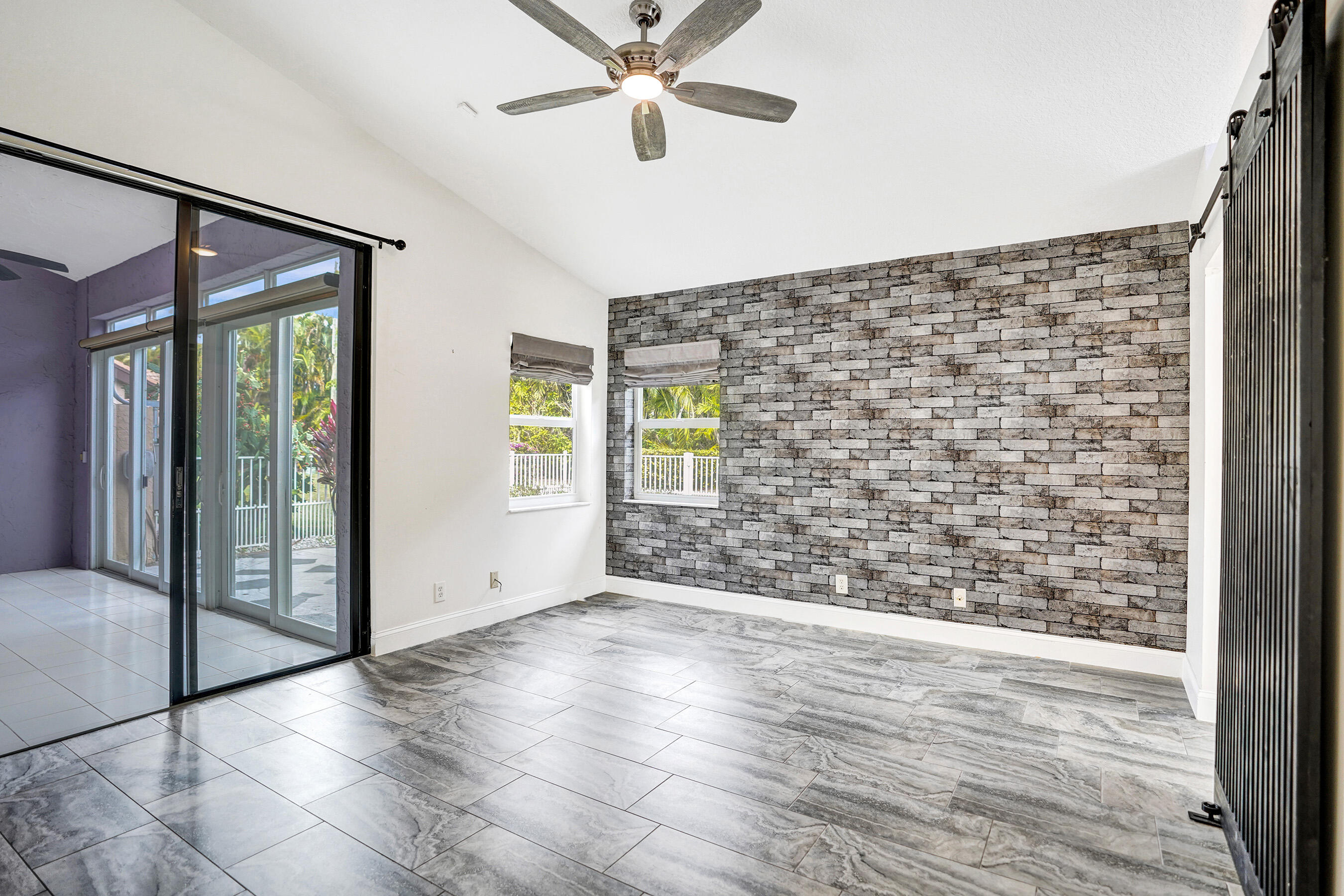 8062 Cassia Drive Boynton Beach, FL 33472 - Photo 20 of 70 an empty room with wooden floor and windows