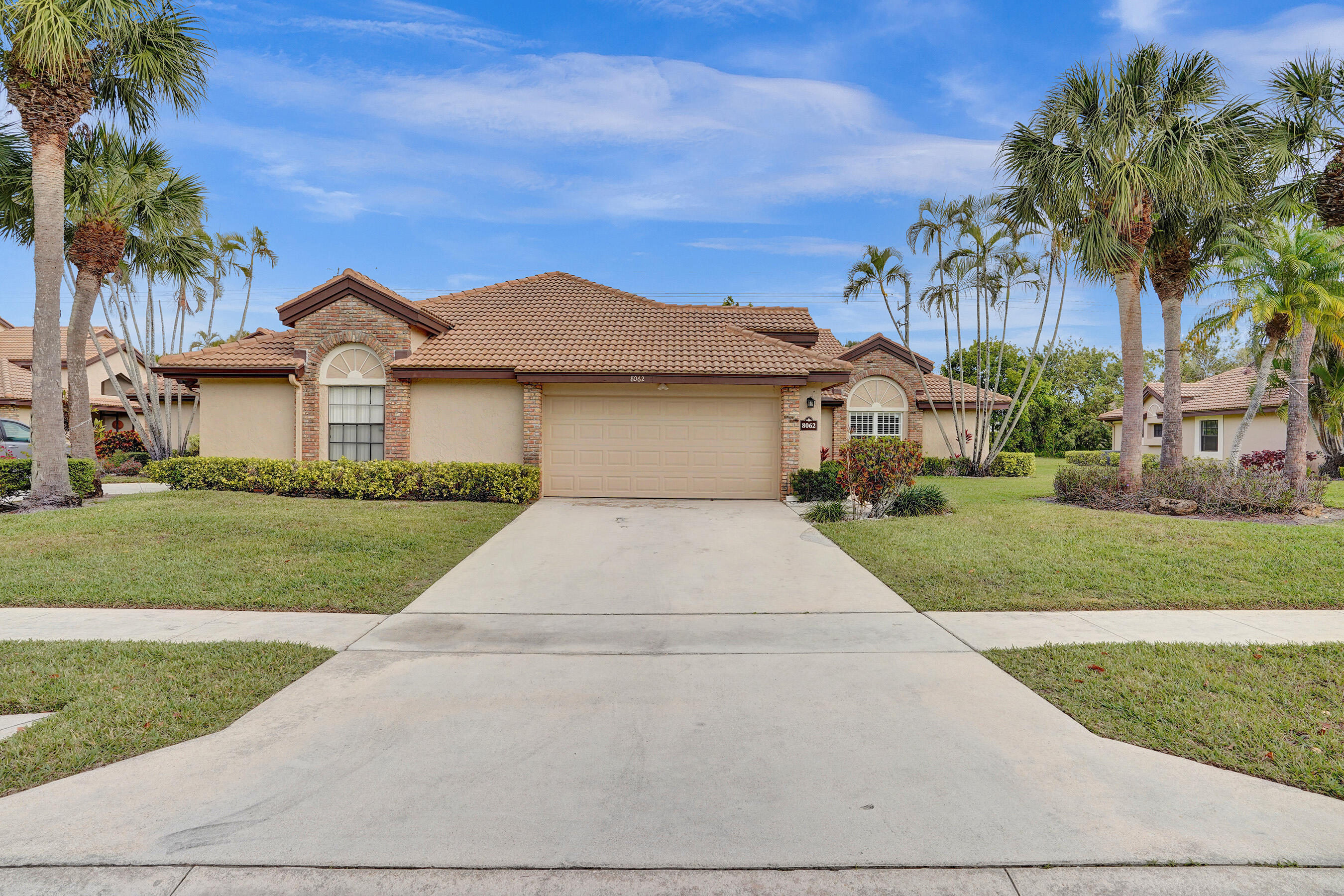 8062 Cassia Drive Boynton Beach, FL 33472 - Photo 3 of 70 a front view of a house with a yard and garage