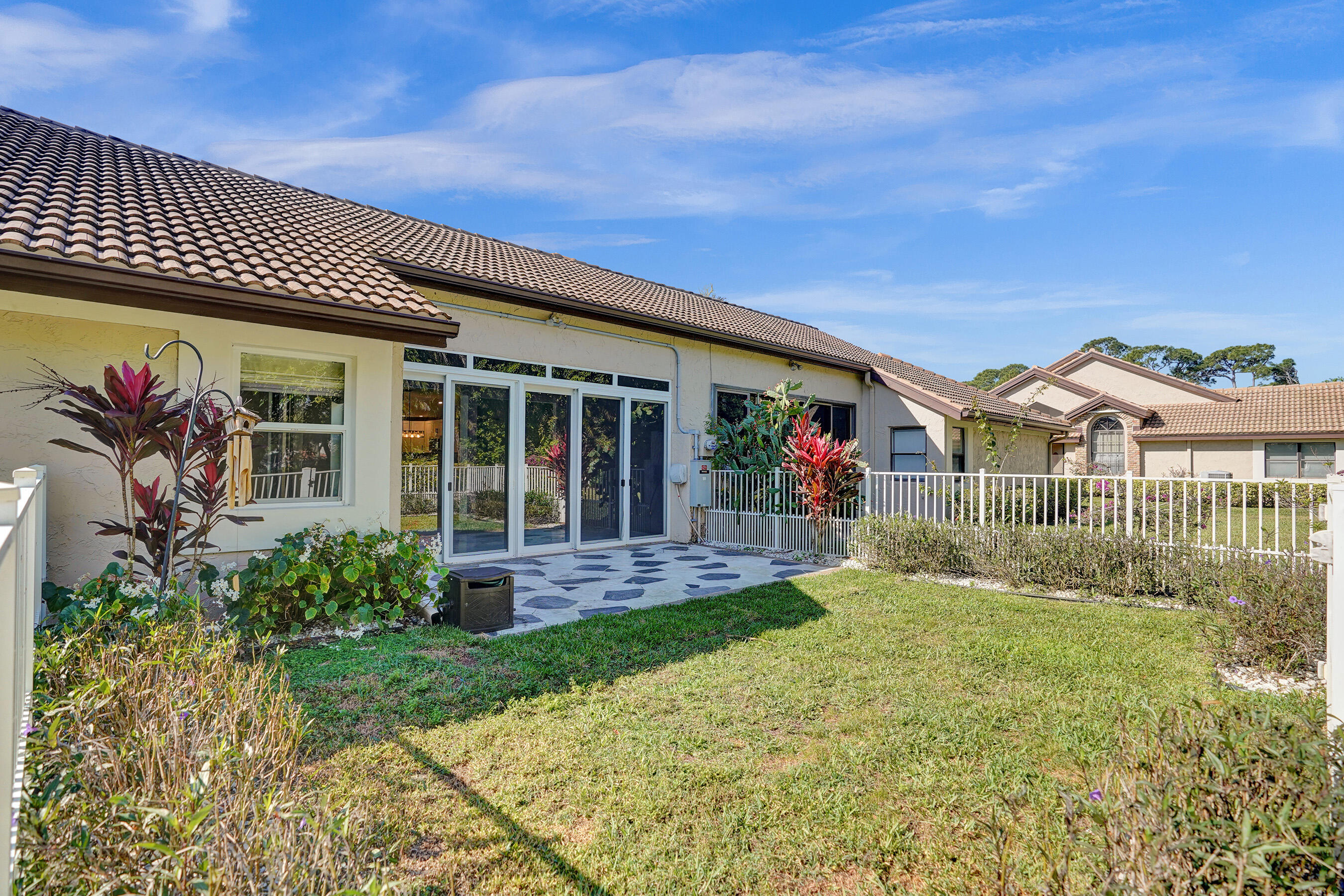8062 Cassia Drive Boynton Beach, FL 33472 - Photo 35 of 70 a view of a brick house with many windows
