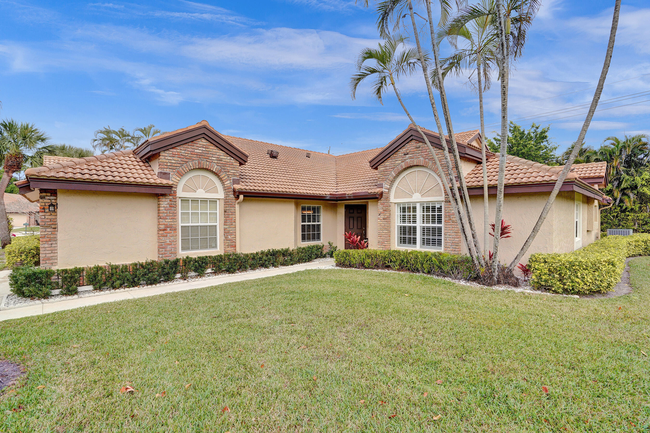 8062 Cassia Drive Boynton Beach, FL 33472 - Photo 4 of 70 a front view of a house with a garden