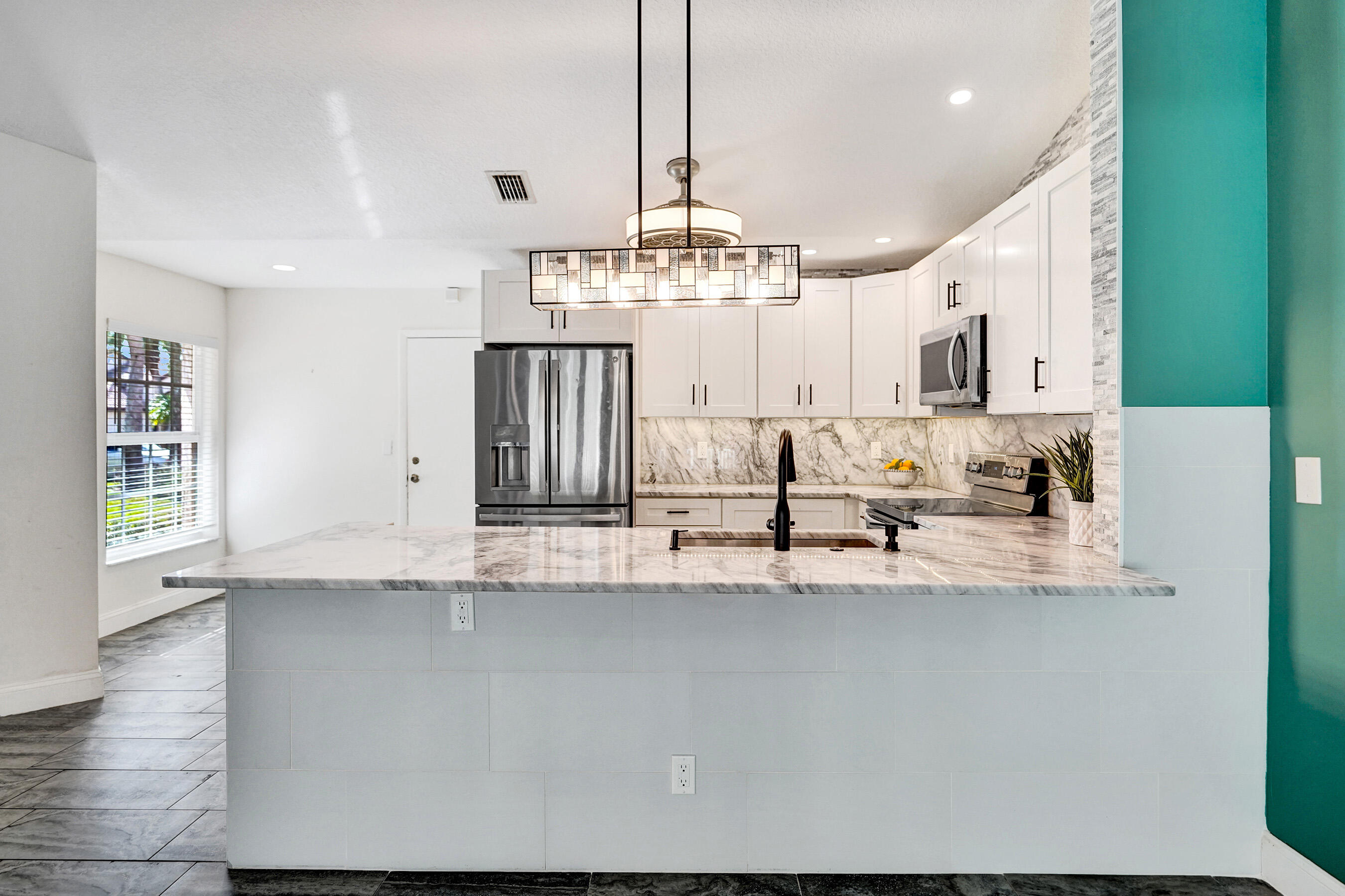 8062 Cassia Drive Boynton Beach, FL 33472 - Photo 7 of 70 a view of a kitchen with granite countertop a sink and dishwasher a stove with wooden floor