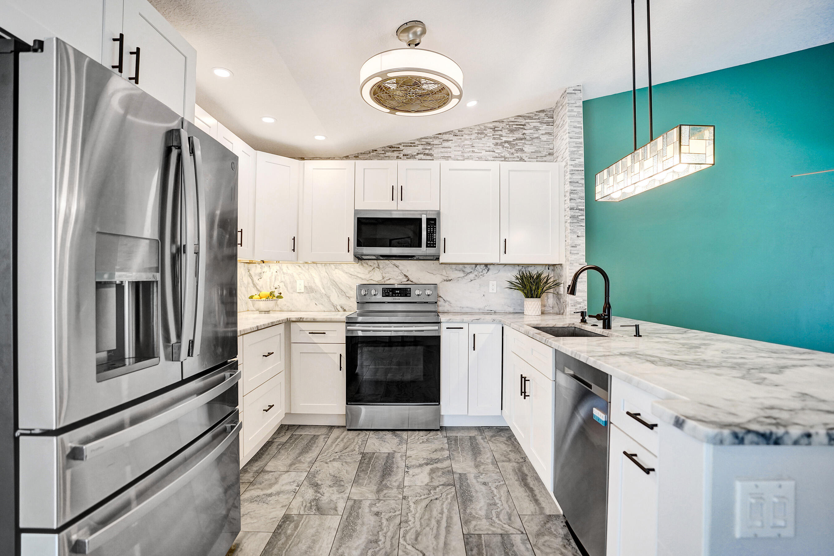 8062 Cassia Drive Boynton Beach, FL 33472 - Photo 8 of 70 a kitchen with a stove microwave and refrigerator