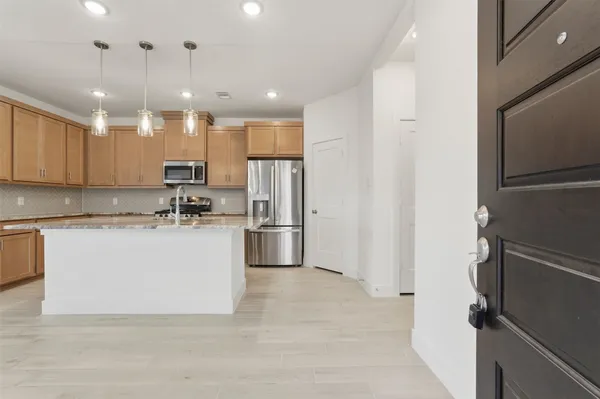 a view of kitchen with refrigerator cabinets and a counter top space