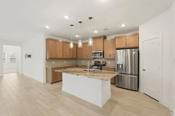 a kitchen with stainless steel appliances granite countertop a refrigerator sink and cabinets