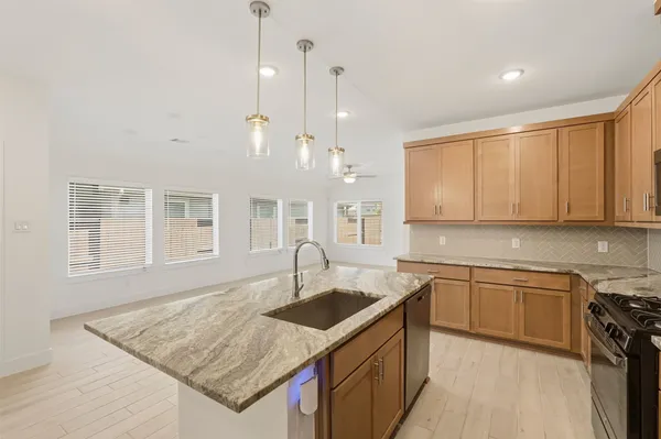 a kitchen with a sink stove and cabinets
