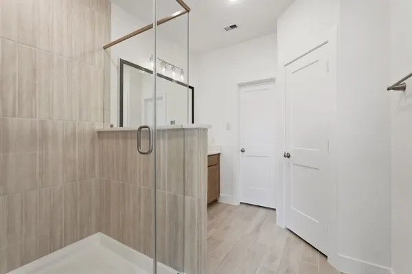 a bathroom with a shower and a tub