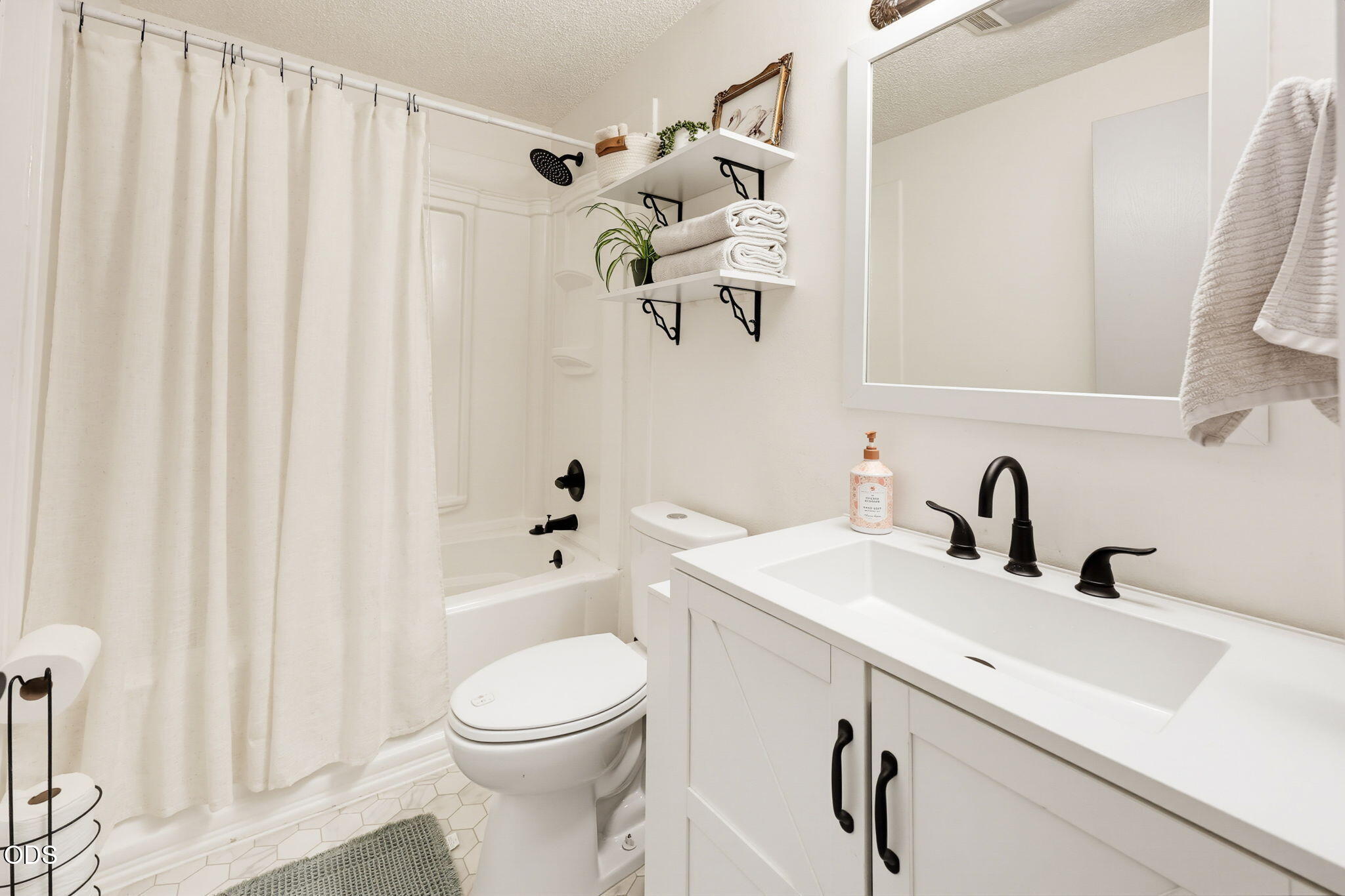 1325 Spring Street Medford, OR 97504 - Photo 13 of 27 a bathroom with a sink a toilet and shower curtain