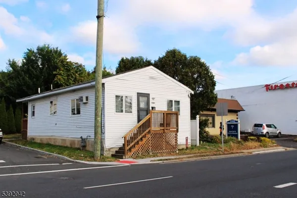 a view of a street in front of a house