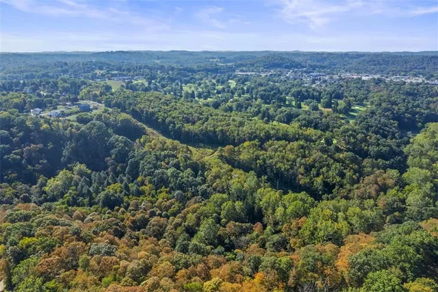 an aerial view of a houses with a yard