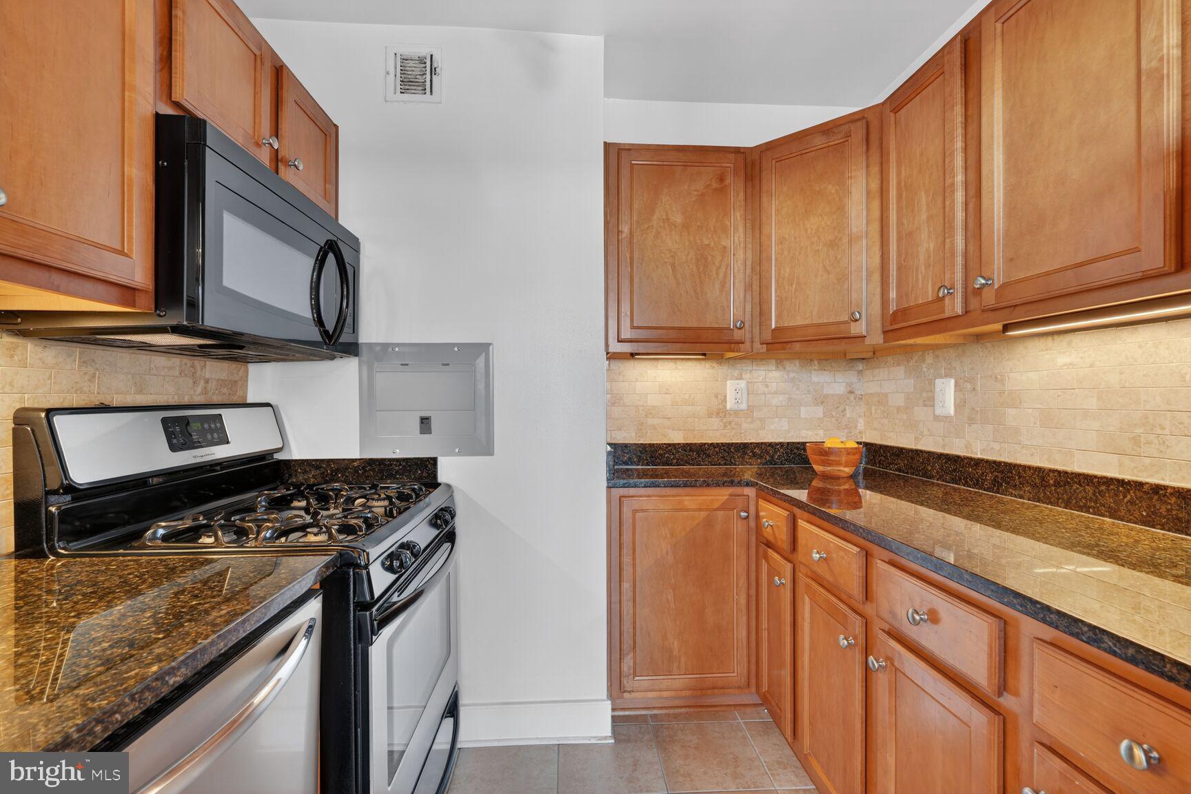 1220 Blair Mill Road, Unit 1403 Silver Spring, MD 20910 - Photo 14 of 40 a kitchen with stainless steel appliances granite countertop a sink stove and cabinets