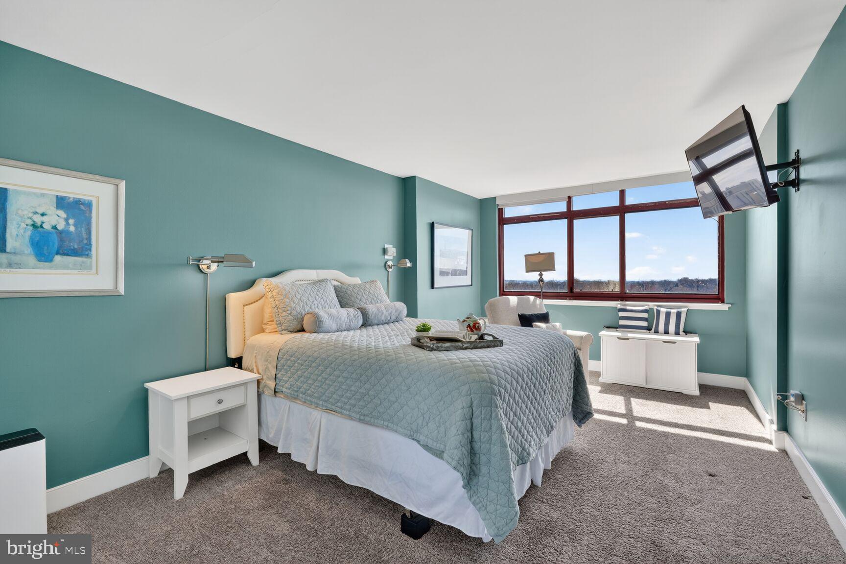 1220 Blair Mill Road, Unit 1403 Silver Spring, MD 20910 - Photo 18 of 40 a bedroom with a bed and a table