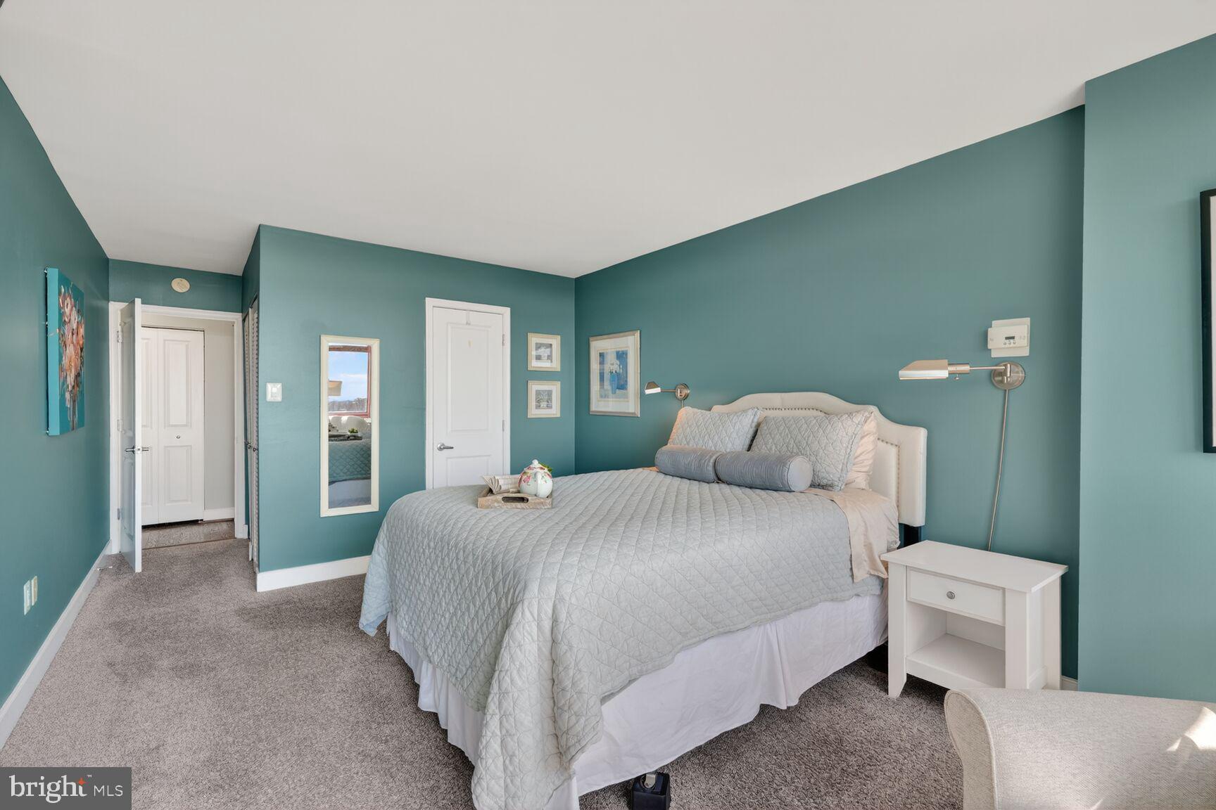 1220 Blair Mill Road, Unit 1403 Silver Spring, MD 20910 - Photo 21 of 40 a bedroom with a bed and a large mirror