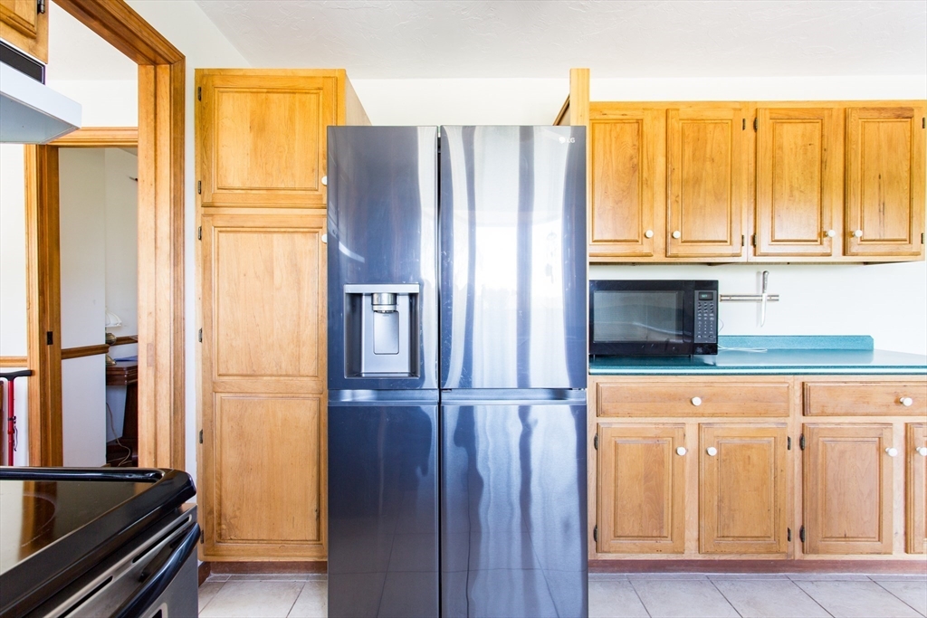 9 Birch Hill Road West Brookfield, MA 01585 - Photo 11 of 38 a kitchen with windows and refrigerator
