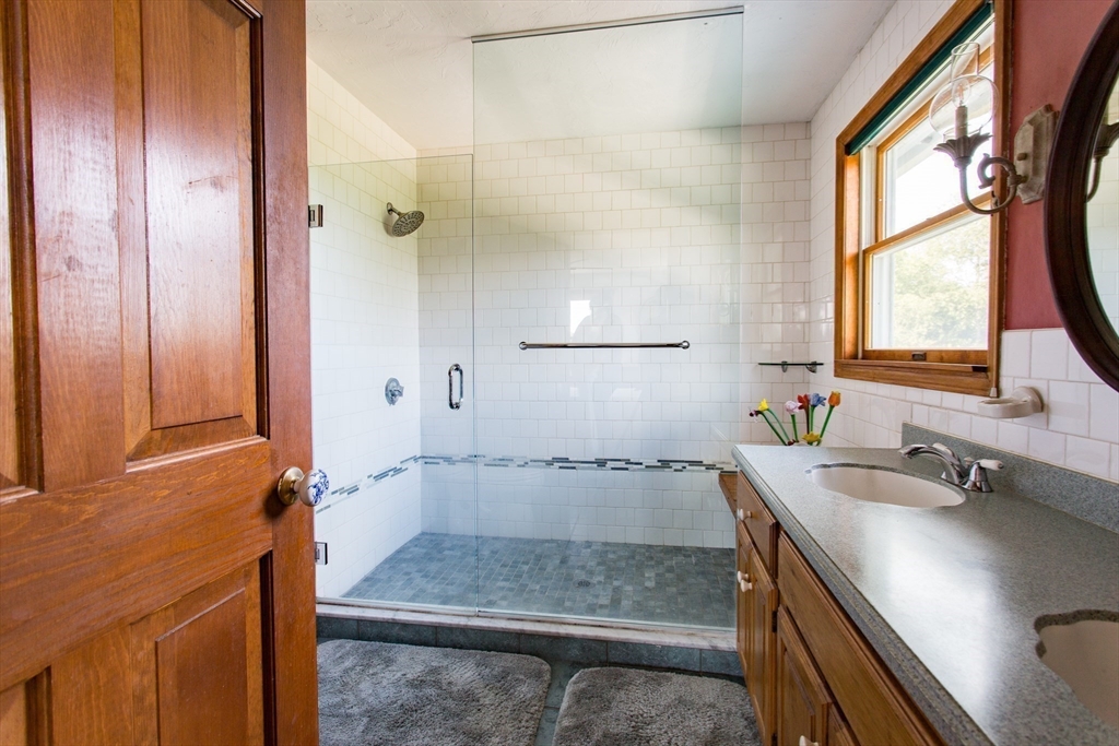 9 Birch Hill Road West Brookfield, MA 01585 - Photo 25 of 38 a bathroom with a granite countertop sink a mirror and shower