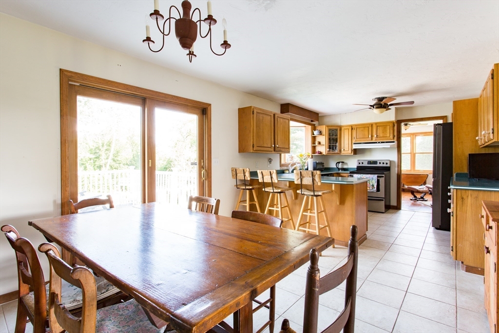 9 Birch Hill Road West Brookfield, MA 01585 - Photo 8 of 38 a dining room with wooden floor a chandelier a glass table and chairs