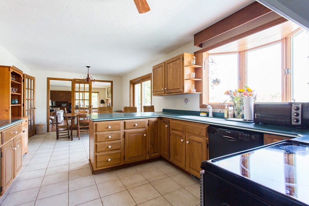 9 Birch Hill Road West Brookfield, MA 01585 - Photo 10 of 38 a kitchen with stainless steel appliances sink cabinets and window