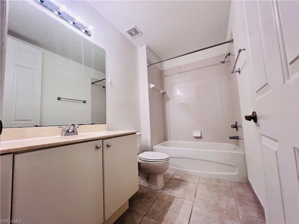 1435 Mariposa Circle, Unit 102 Naples, FL 34105 - Photo 15 of 24 a bathroom with a sink a toilet and shower