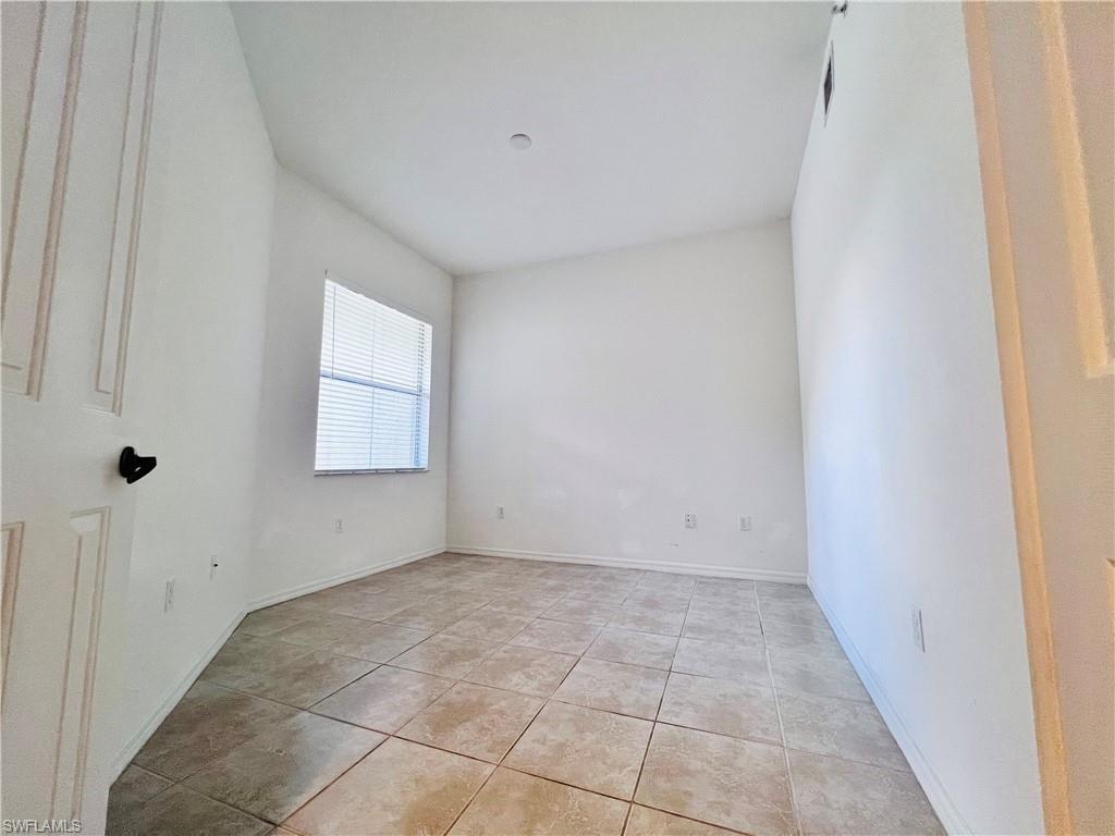 1435 Mariposa Circle, Unit 102 Naples, FL 34105 - Photo 16 of 24 a view of an empty room with a window