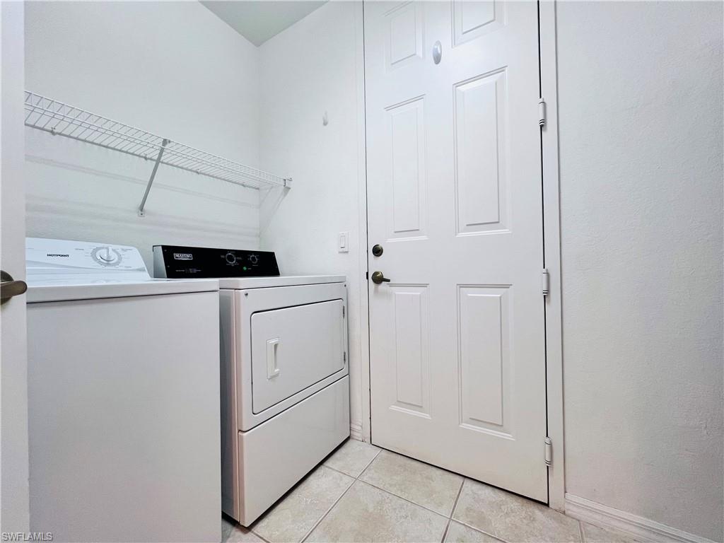 1435 Mariposa Circle, Unit 102 Naples, FL 34105 - Photo 19 of 24 a utility room with dryer and washer